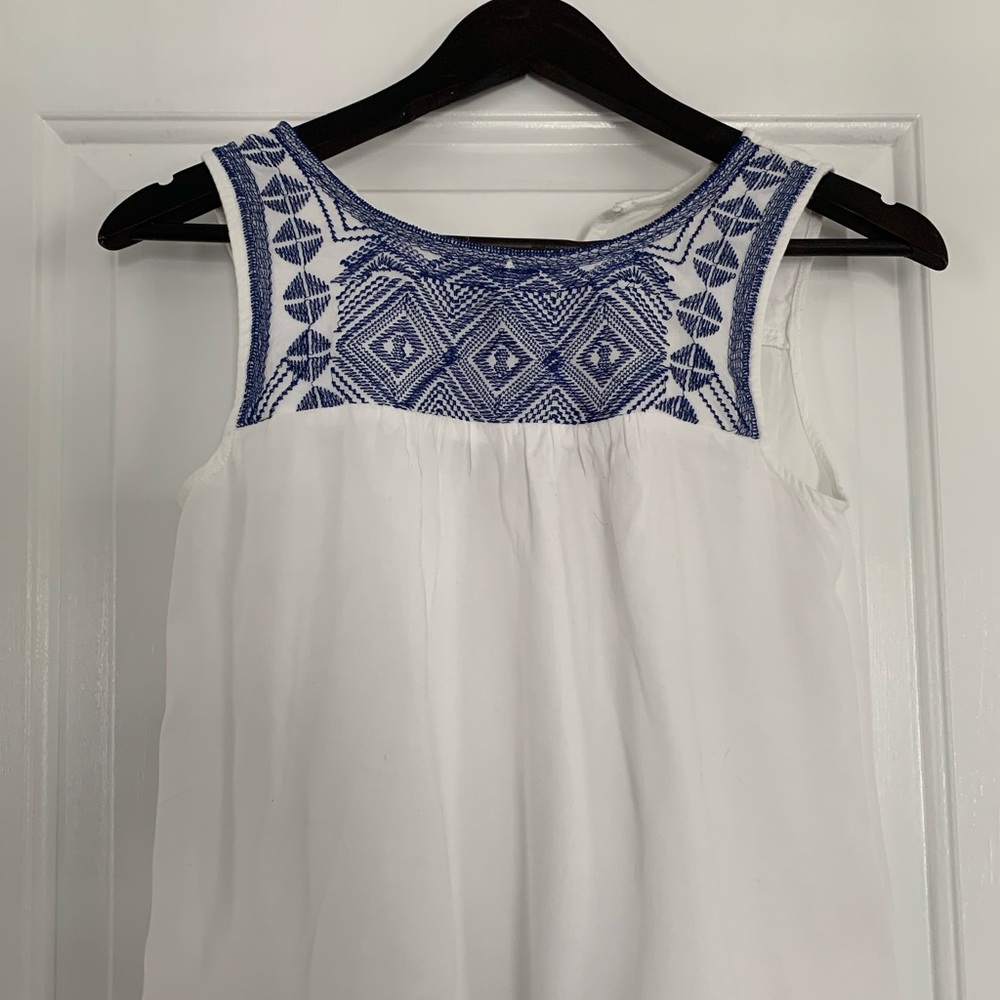 Embroidered crop tank with pompom hem detail